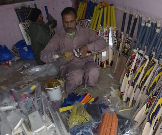 Photo (from the pamphlet, not a data chart): a cricket bat workshop in Sialkot.