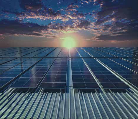 Photo (from the pamphlet, not a data chart): solar panels at sunset, illustrating one of the renewable sources the pamphlet discusses.