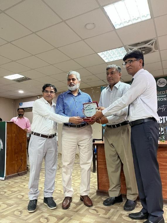 Photo from the report: a shield presentation at ADS's Climate Action Summit at Bahauddin Zakariya University (BZU), 2025.